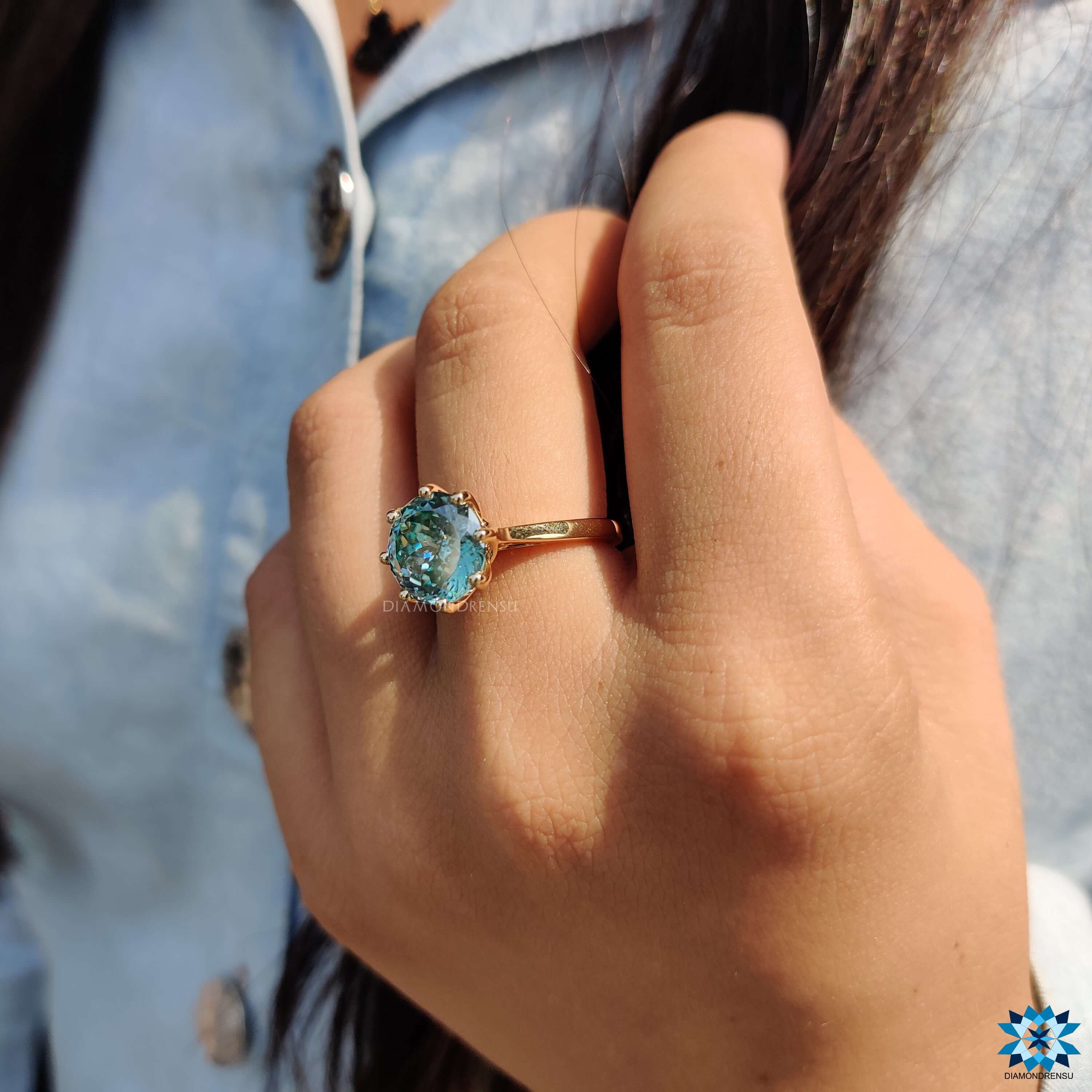 Elegant solitaire engagement ring in warm yellow gold.