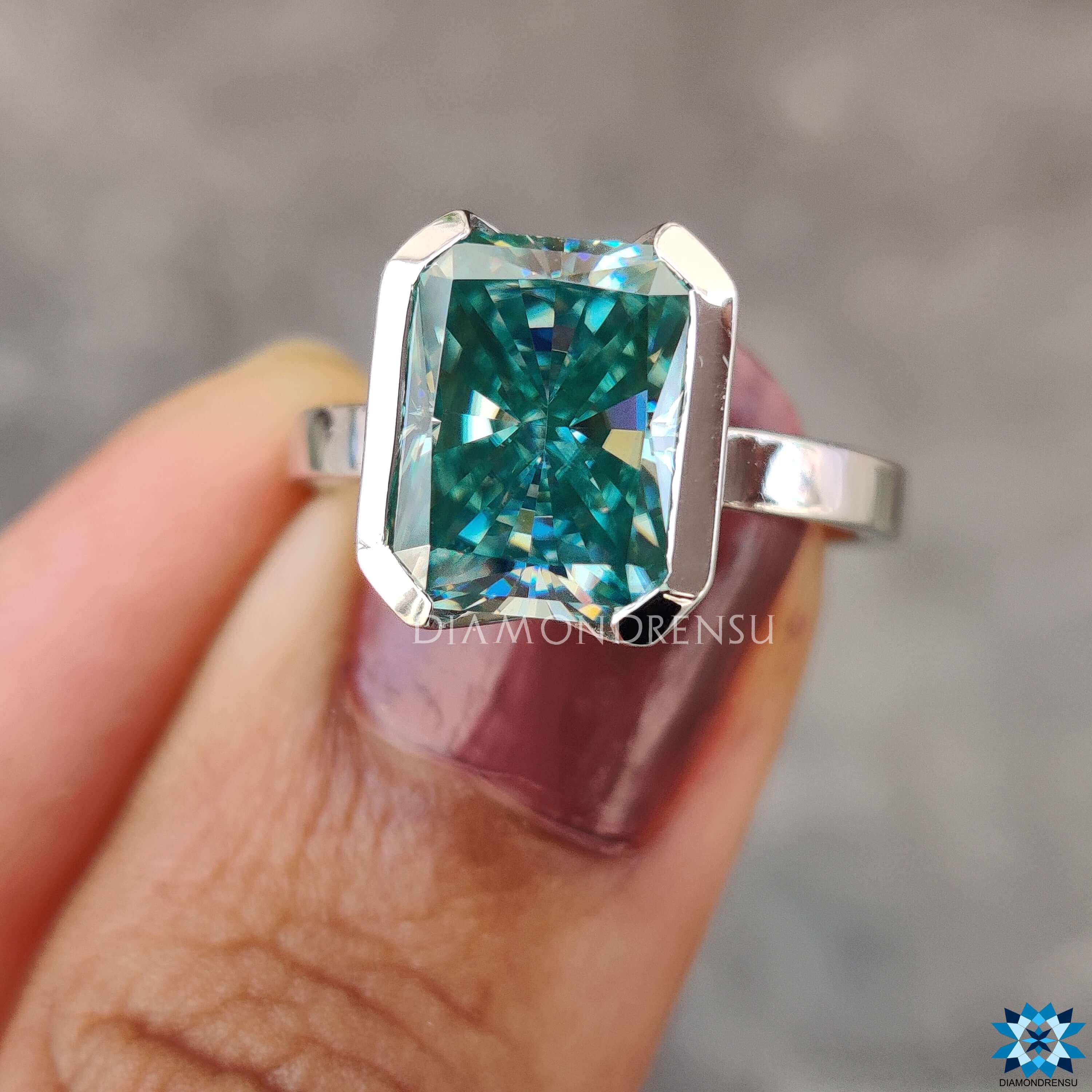 Custom white gold engagement ring featuring radiant moissanite.