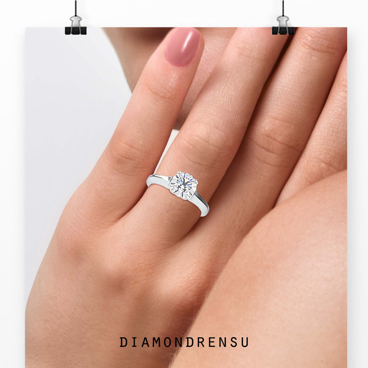 Round cut diamond ring with 4 prong setting, handmade in the UK.