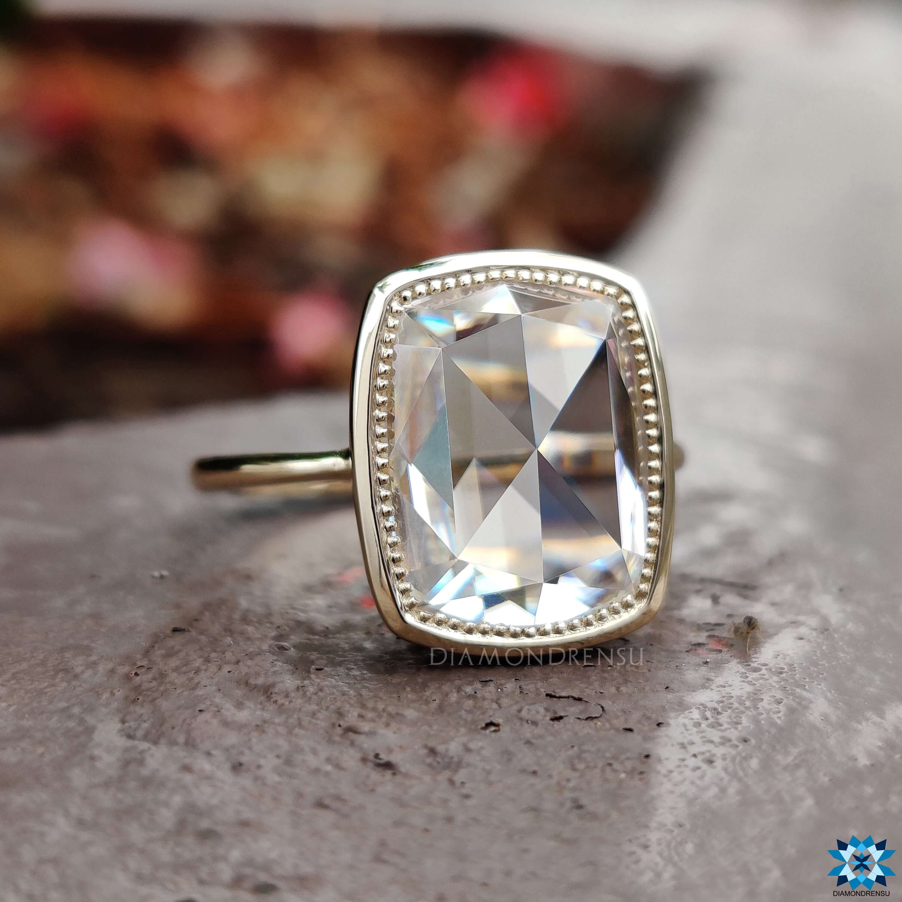 Yellow gold moissanite ring with bezel design.
