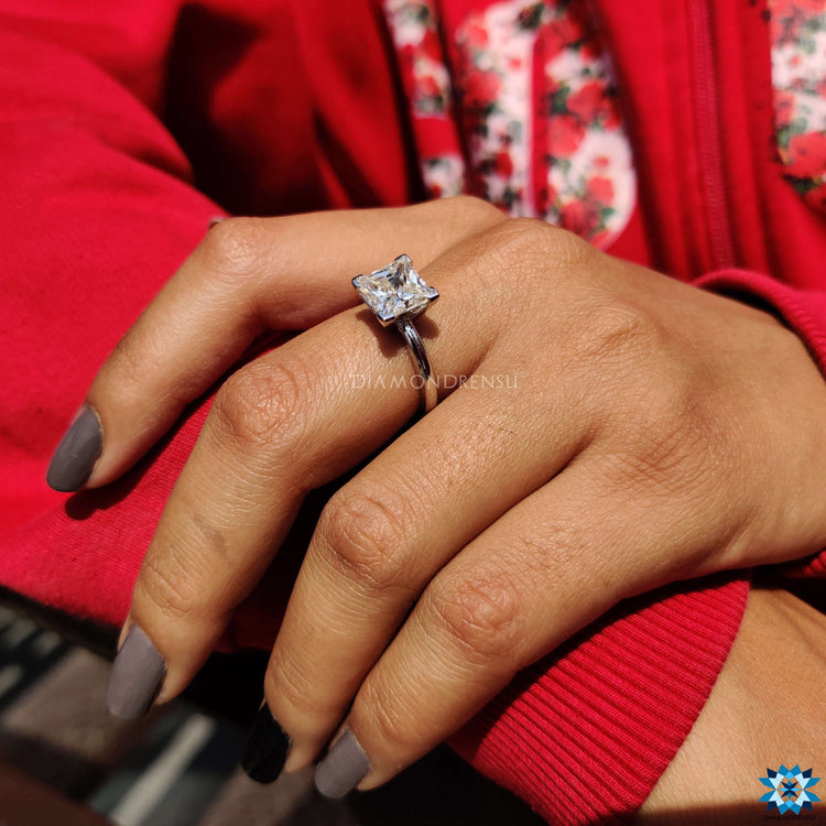 White gold engagement ring with princess cut moissanite.