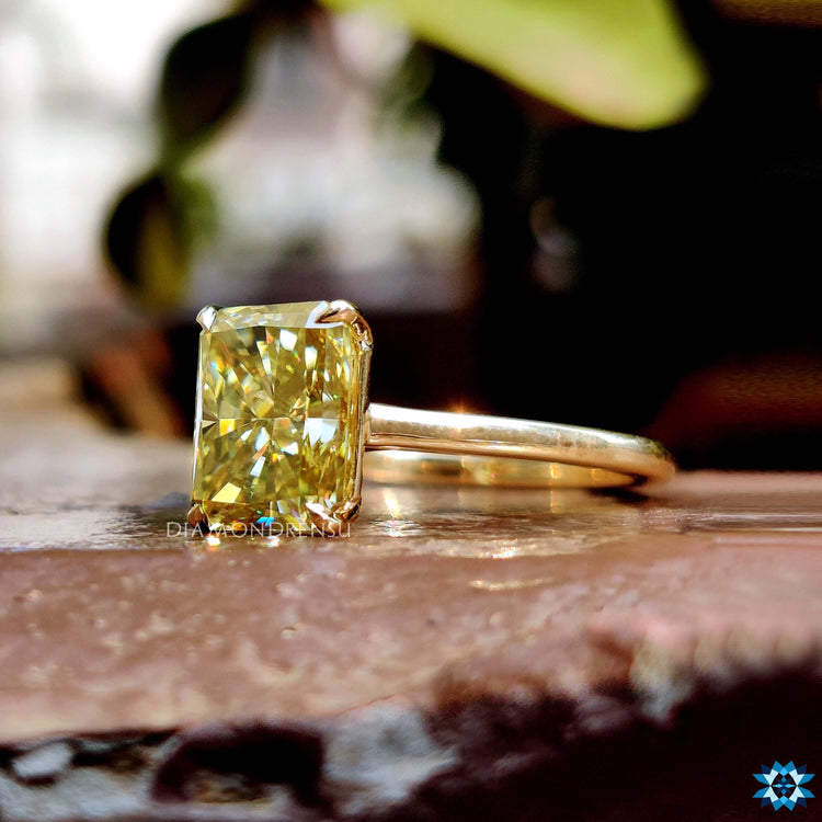 Canary yellow radiant moissanite ring with 4 prong design.