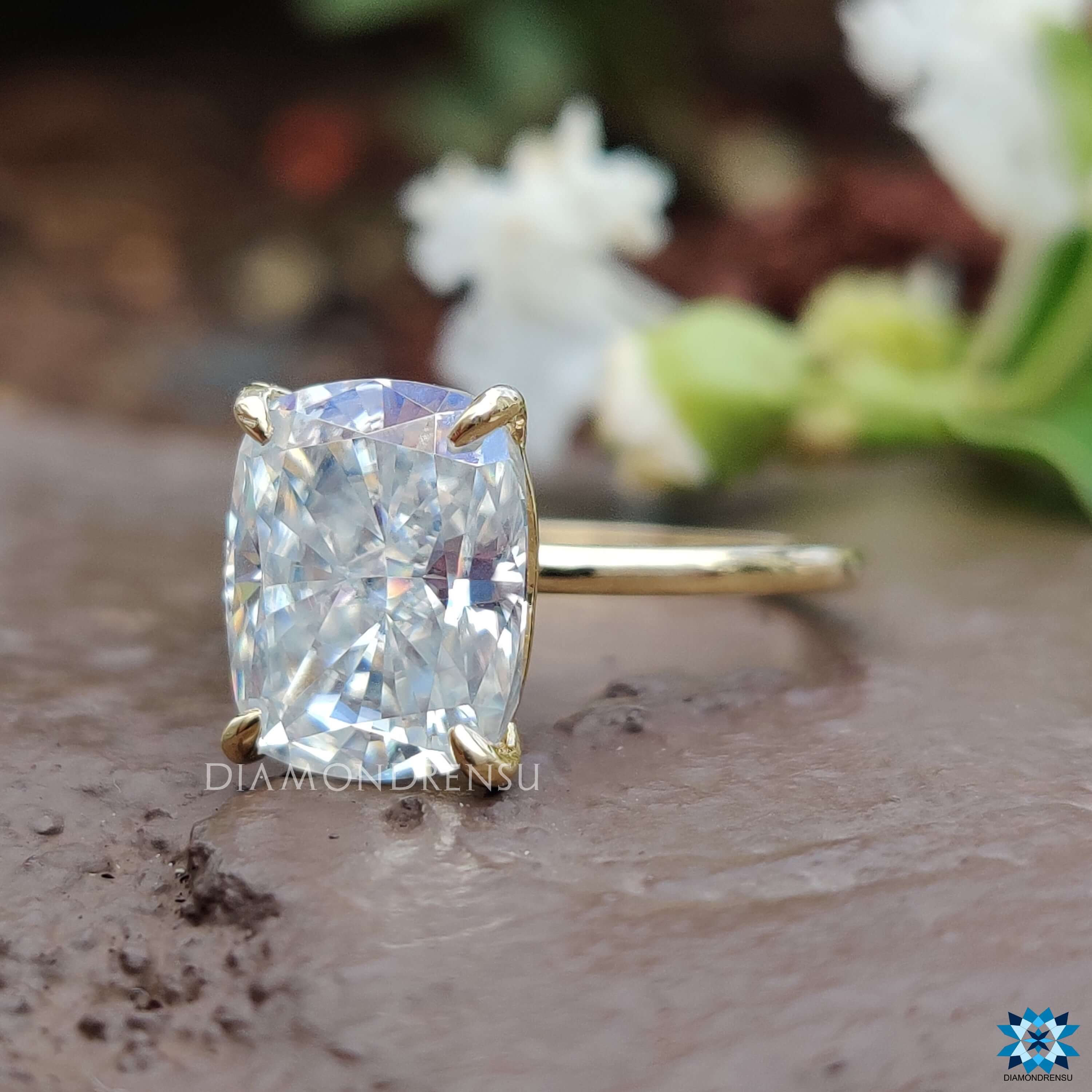 Yellow gold ring with a 4 prong claw setting and cushion cut stone.