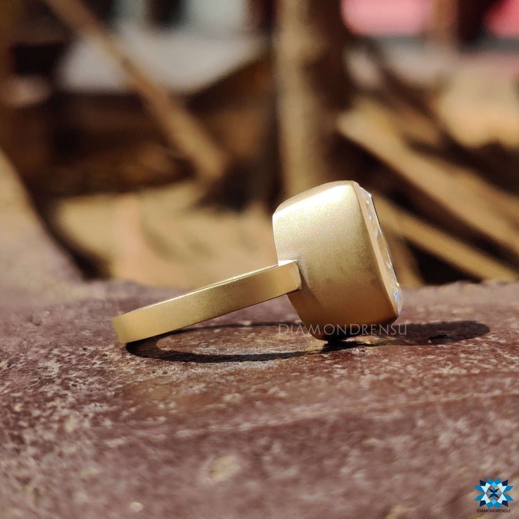 Matte finish yellow gold moissanite ring.