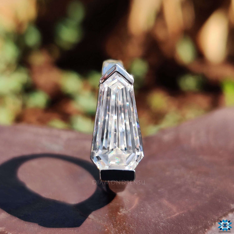White gold moissanite ring with v-shaped prong setting.