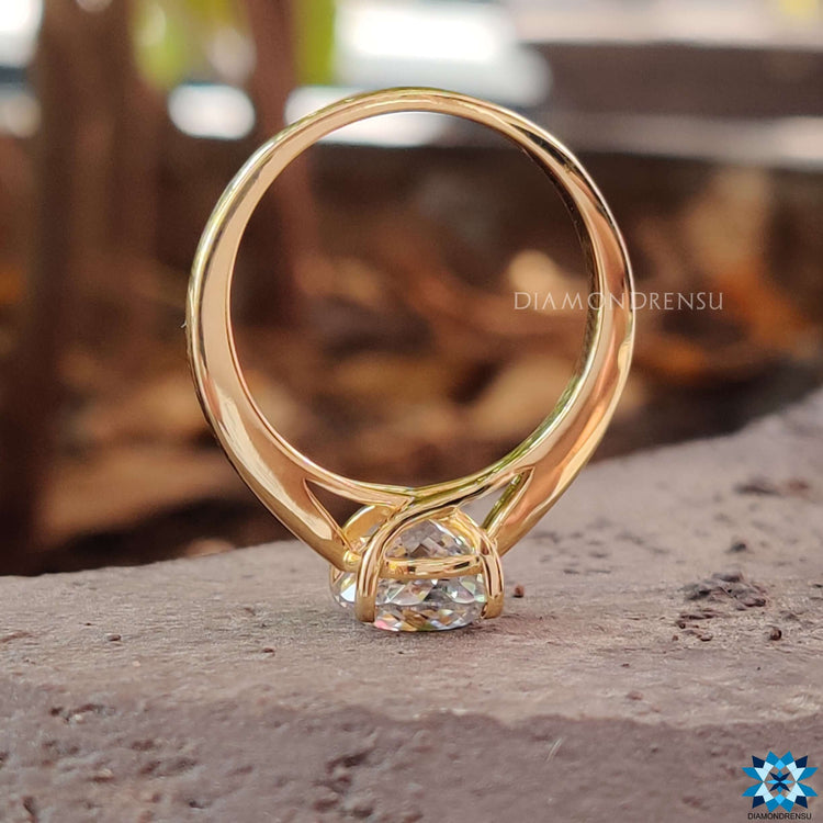 Handmade moissanite ring crafted in yellow gold.