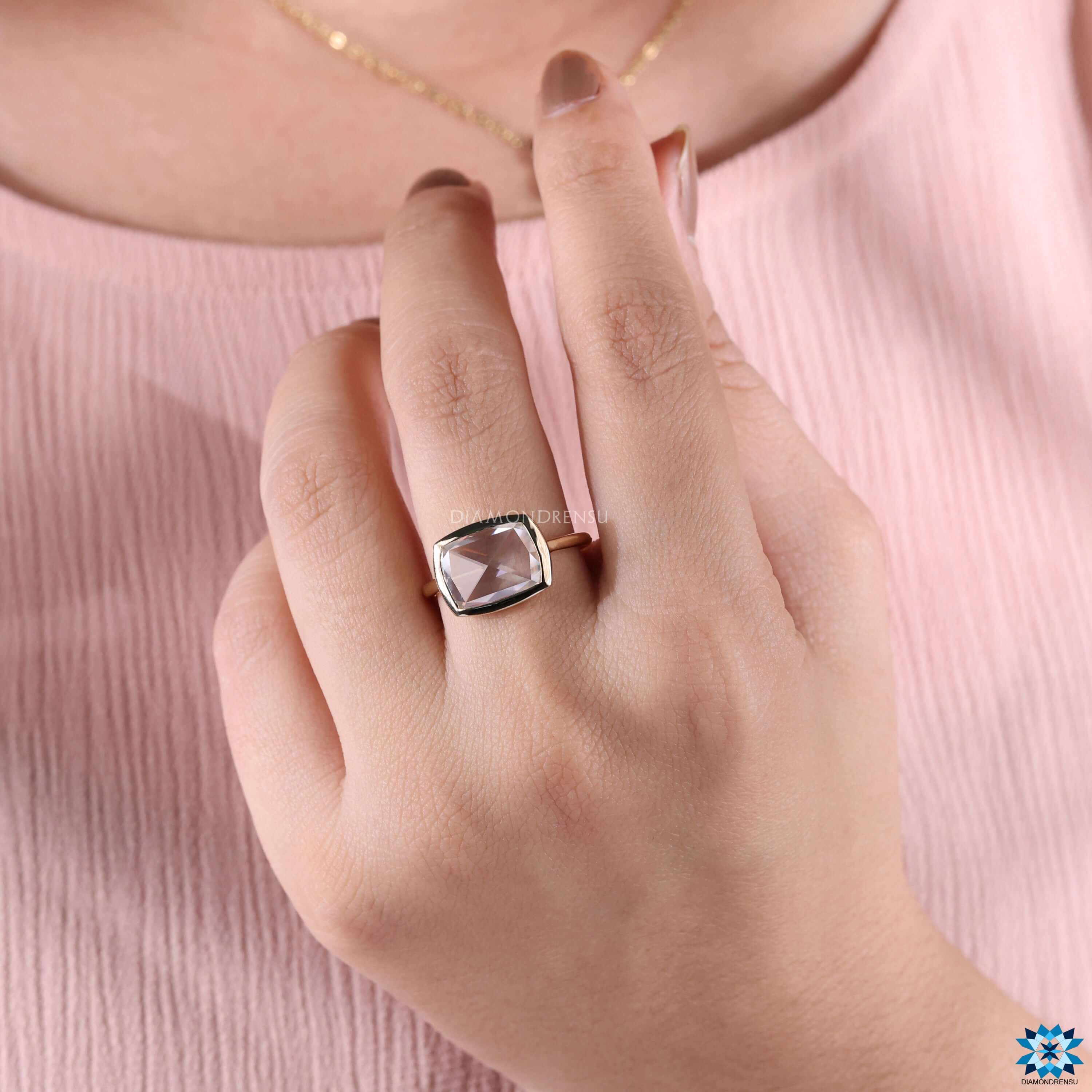 Handmade yellow gold bezel solitaire ring.