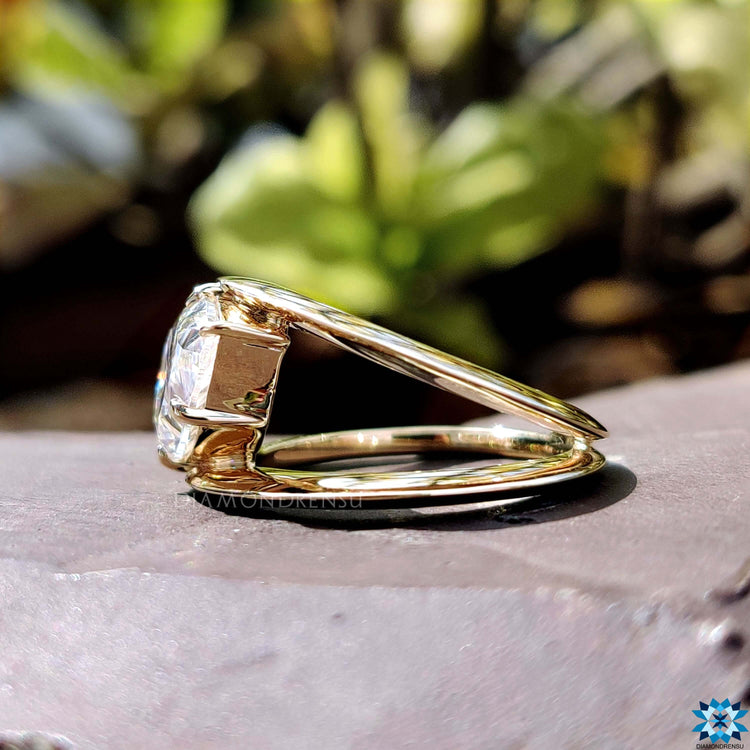 Yellow gold ring featuring pear cut moissanite.
