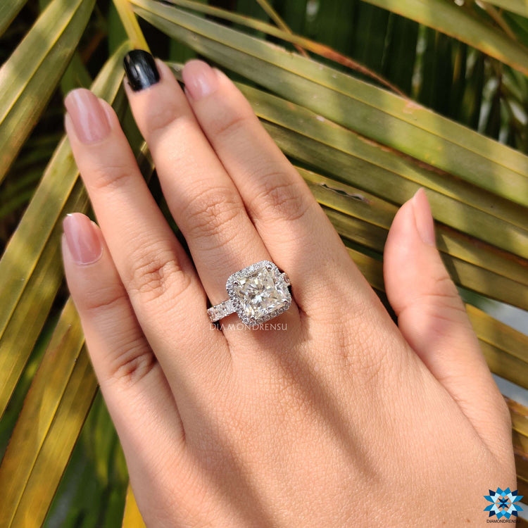 White gold ring featuring square radiant moissanite and hidden halo setting.