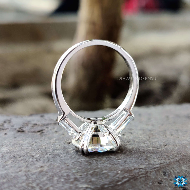 Custom engagement ring with round and baguette moissanites.