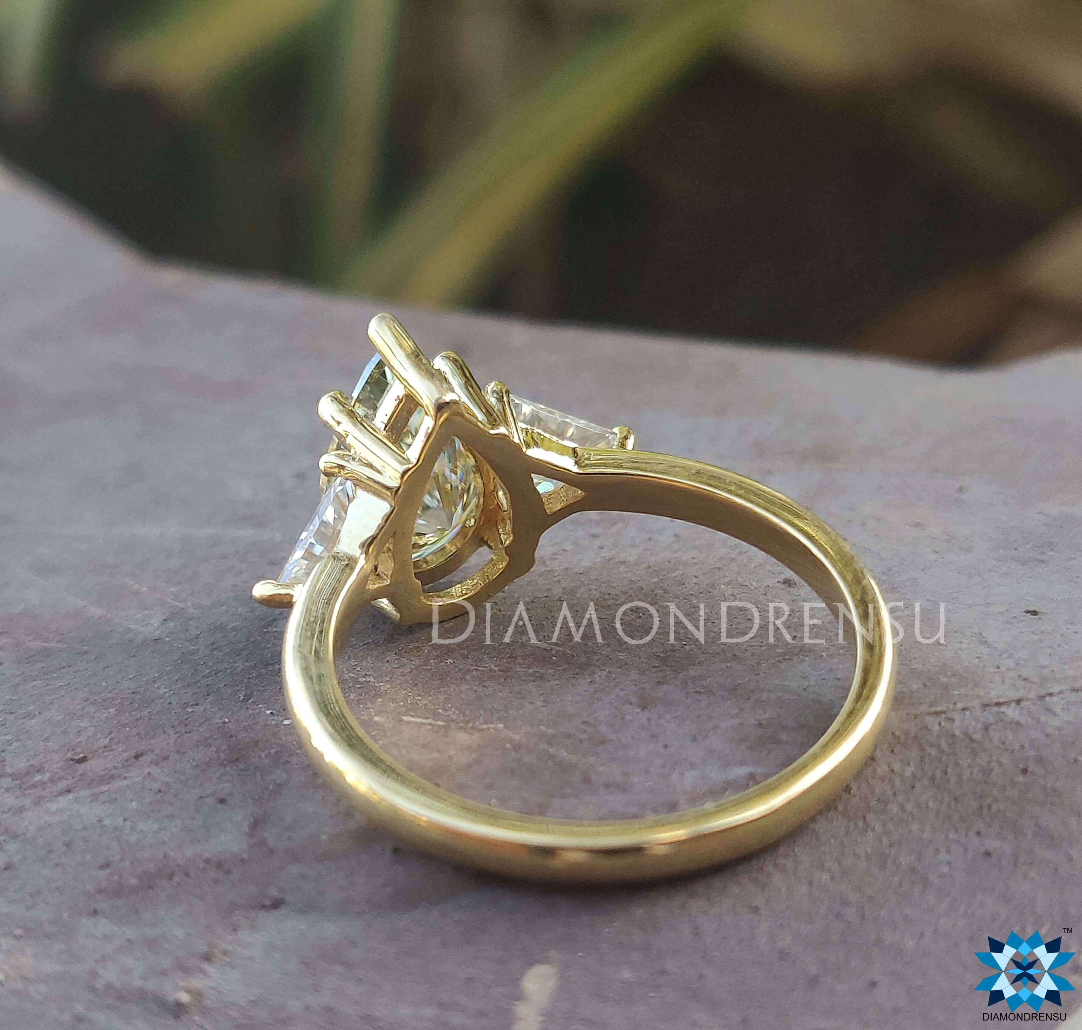 Yellow gold moissanite ring with a beautiful pear shaped centre.