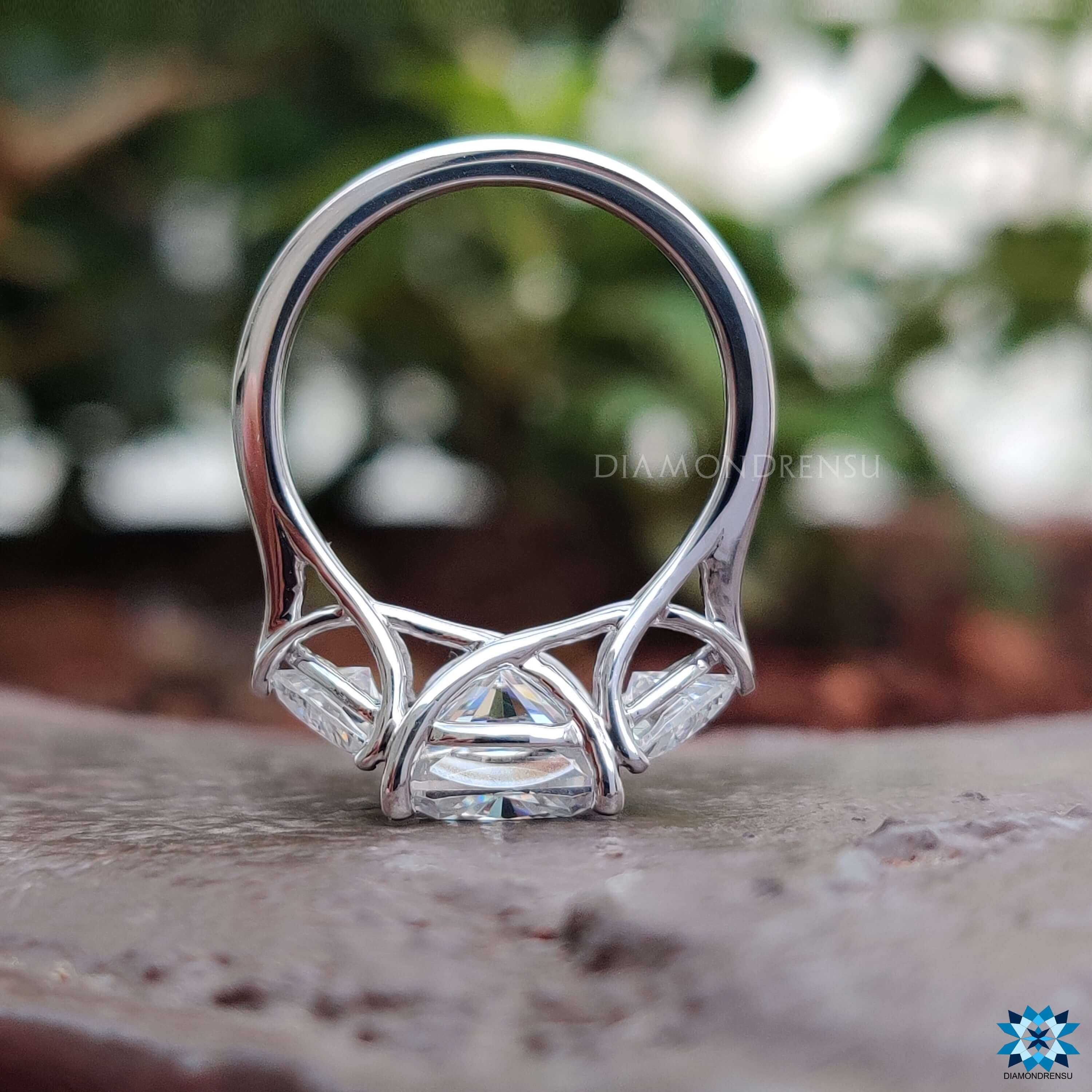 Cushion cut moissanite ring with two trillion cut accents.