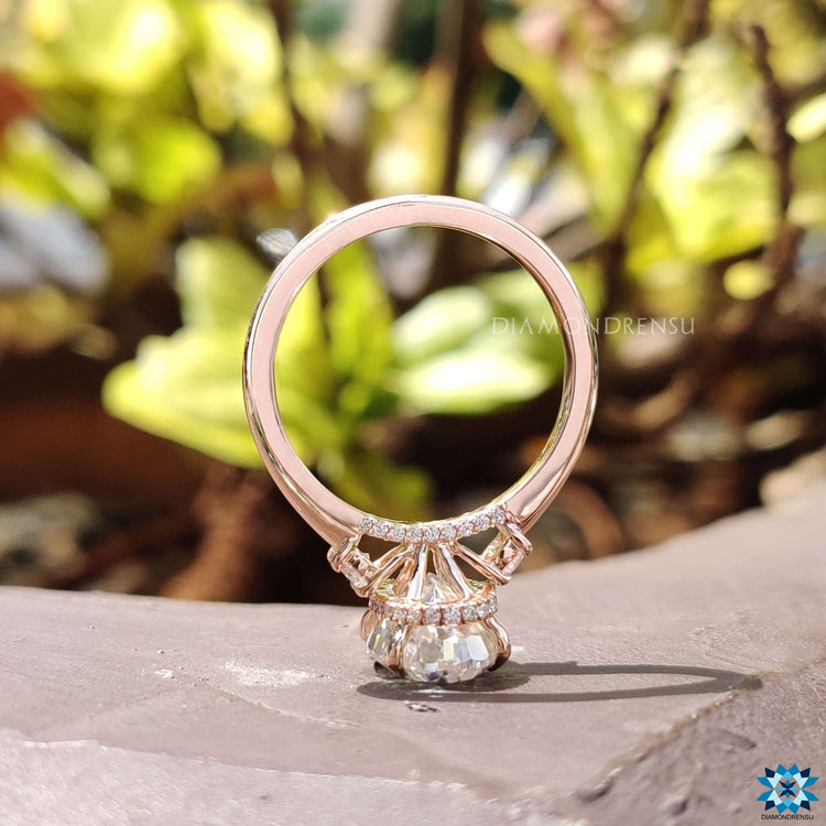 Round cut moissanite ring with hidden halo detail.