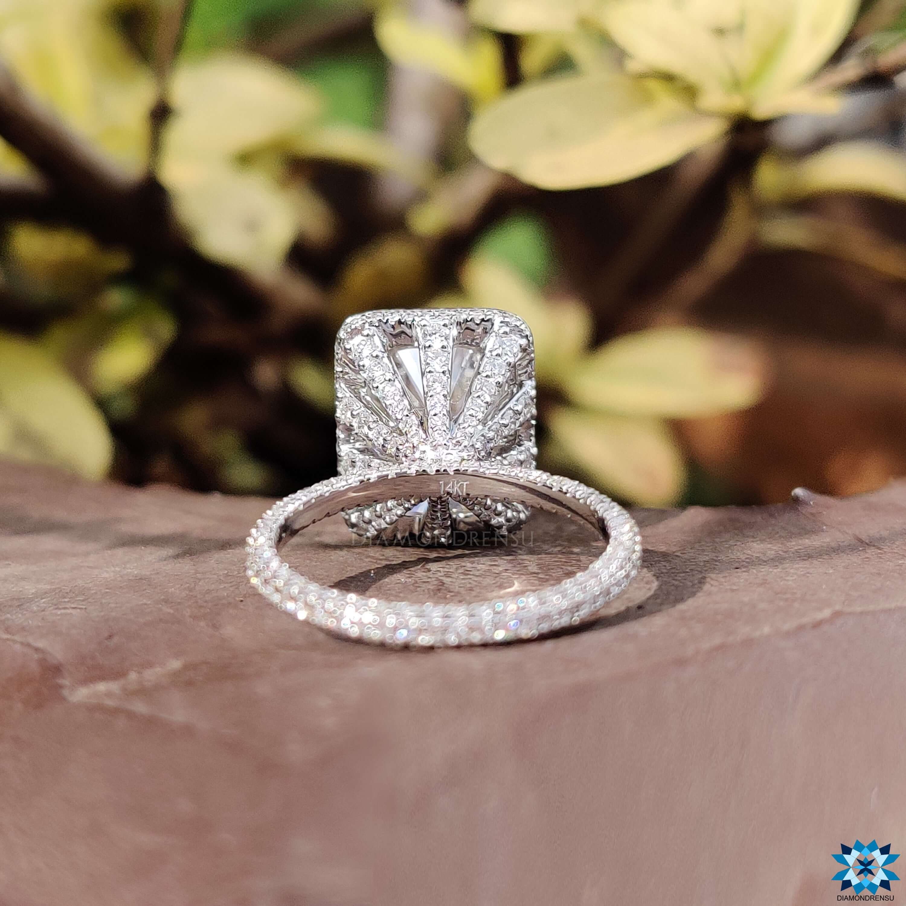White gold ring with halo moissanite setting.