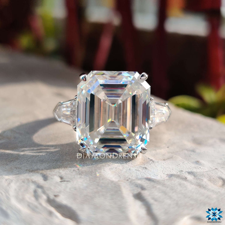Handmade moissanite engagement ring with emerald cut center.