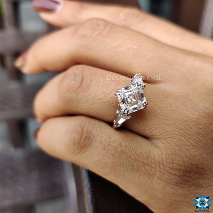 Three stone engagement ring featuring Asscher cut center stone.