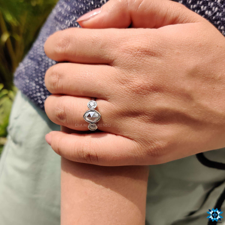 Handmade moissanite ring with oval and round cuts.