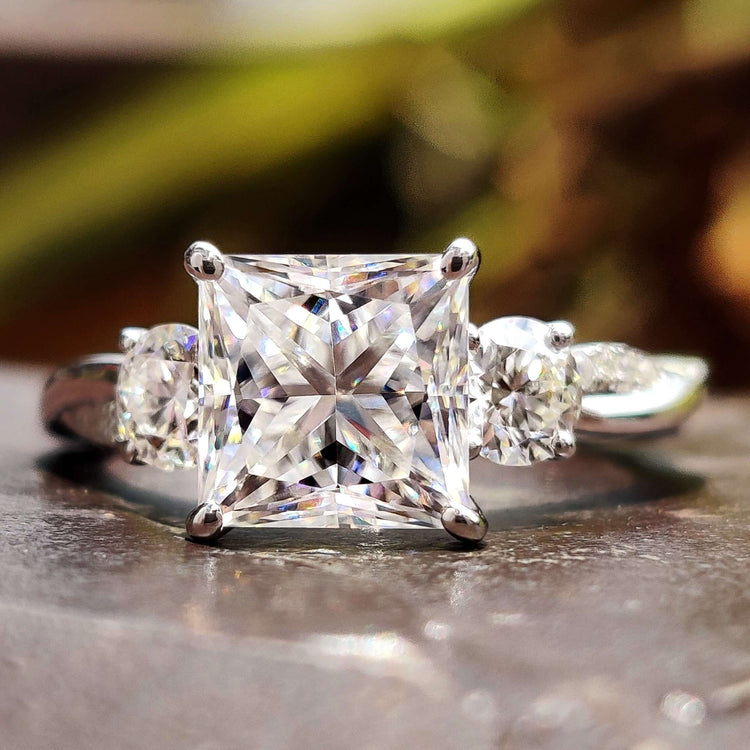 Princess cut moissanite ring with twisted shank.