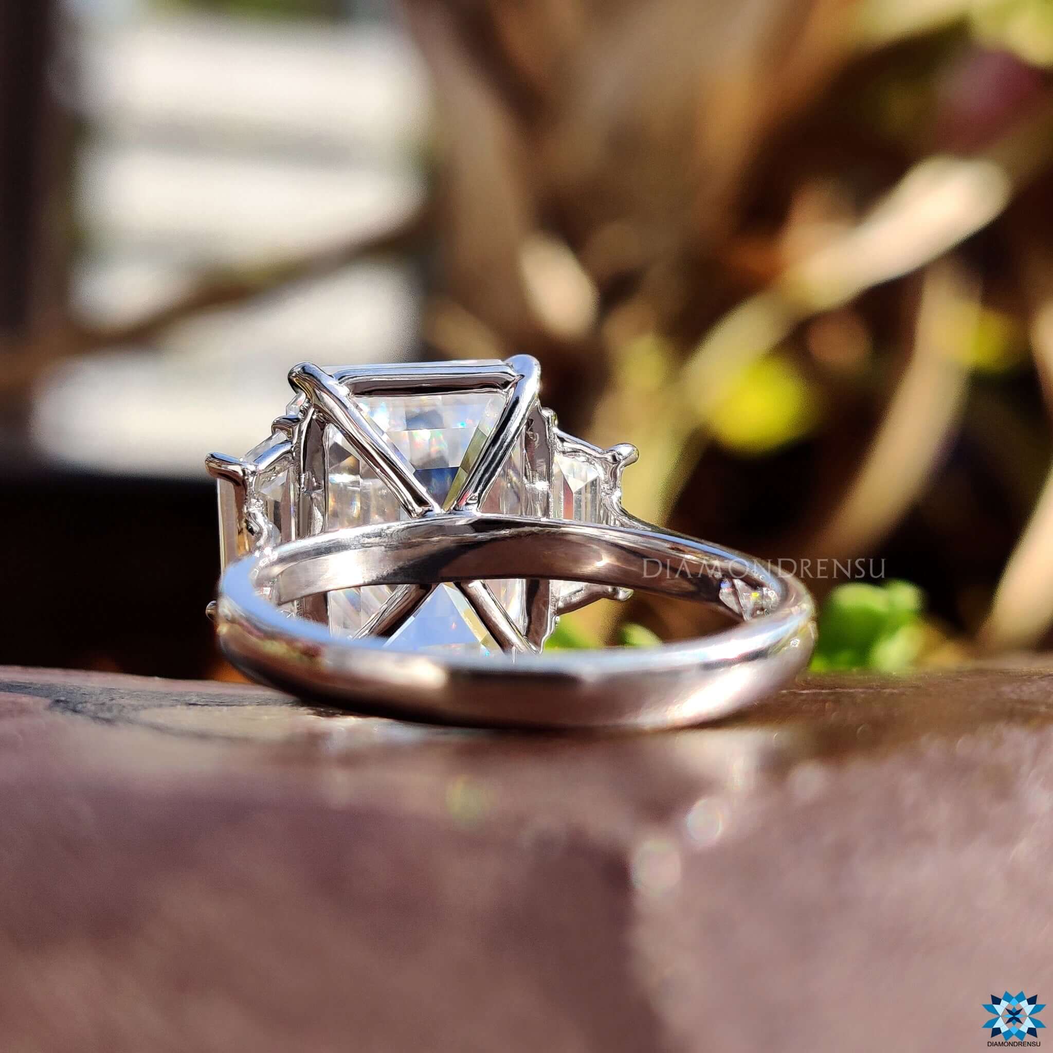 Trapezoid side stone moissanite ring.