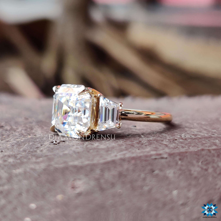 Asscher cut center ring with trapezoid side accents.