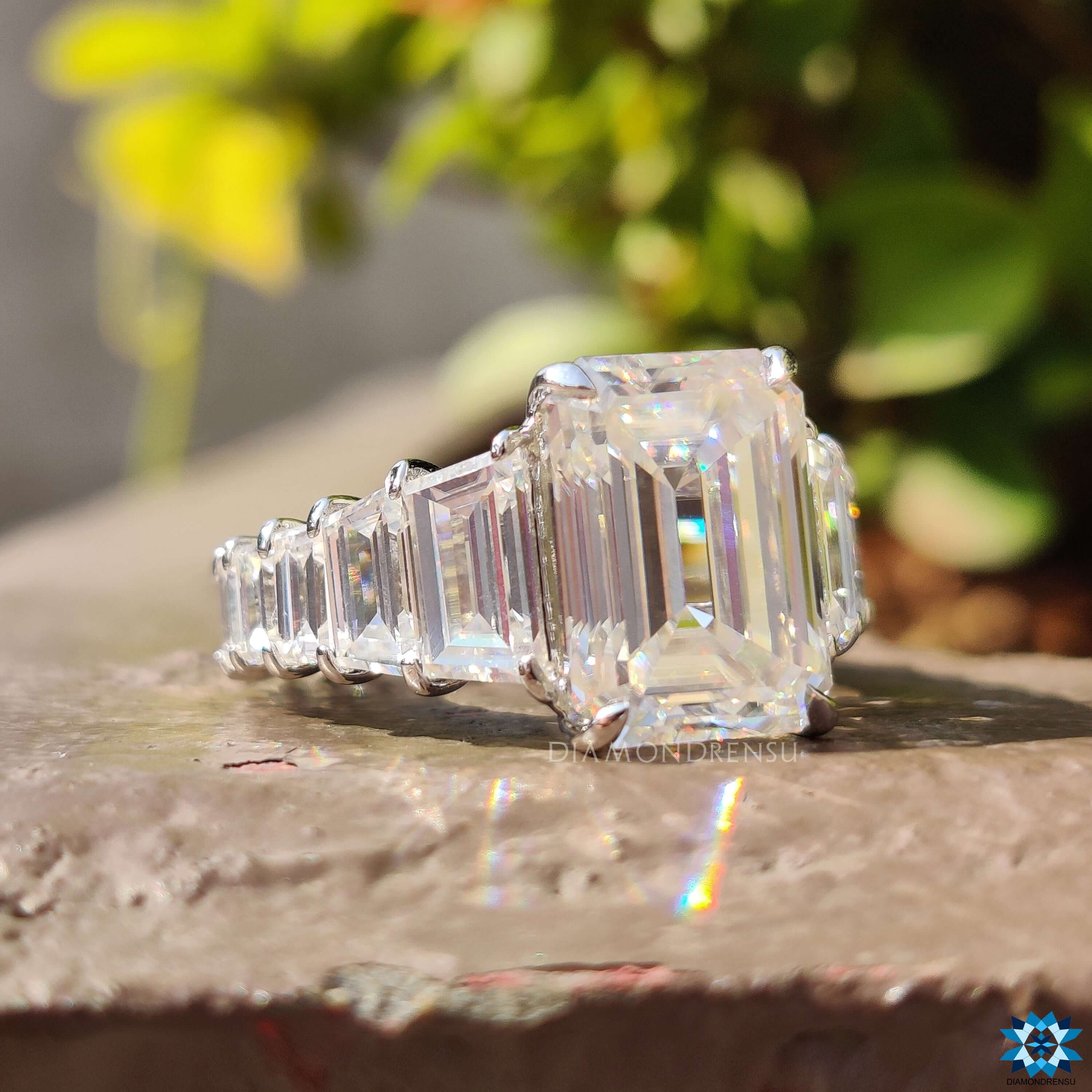 Handmade engagement ring with emerald moissanite and pave accents.