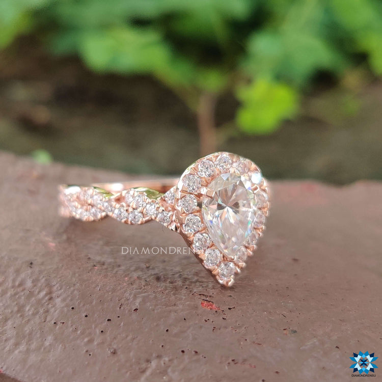 Rose gold moissanite ring with twisted round cut band.