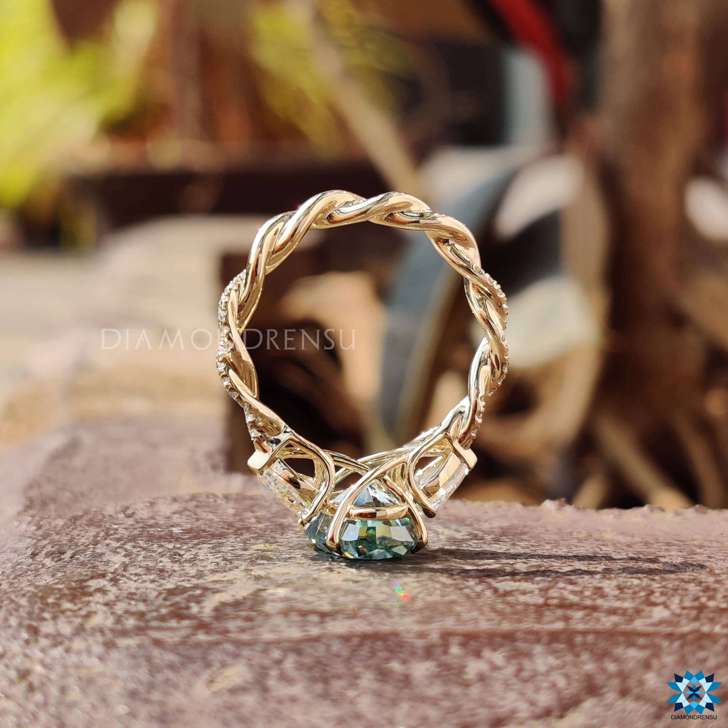 Oval moissanite ring set in yellow gold with a 4 prong claw setting.