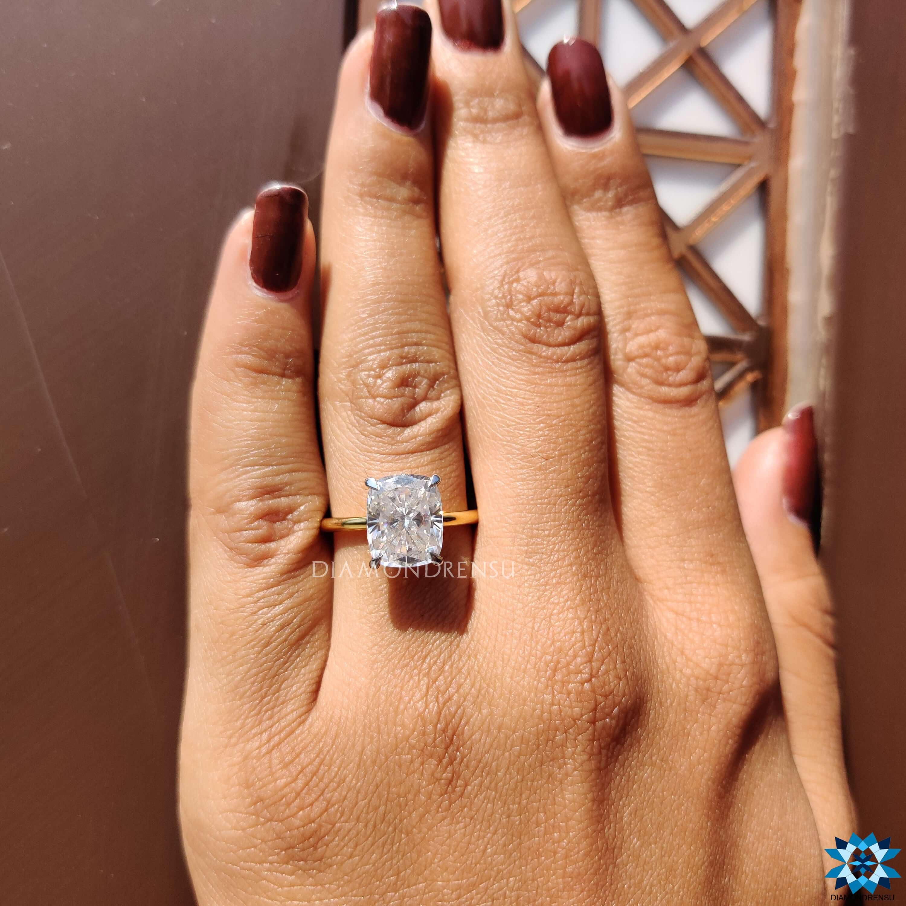 Prong set solitaire ring with elongated cushion center.