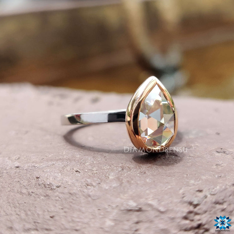 Two tone rose and white gold pear cut engagement ring.