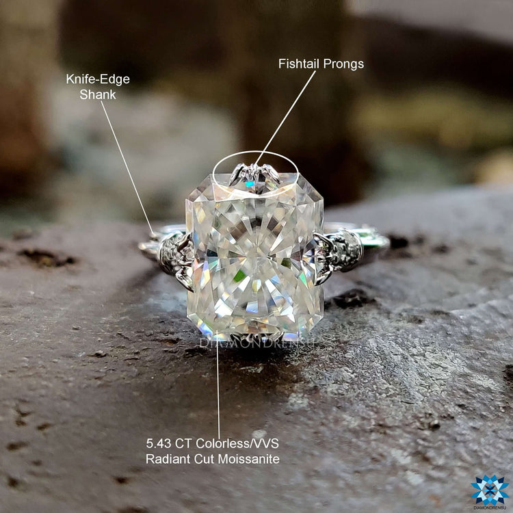 Antique-inspired moissanite ring with milgrain accents.