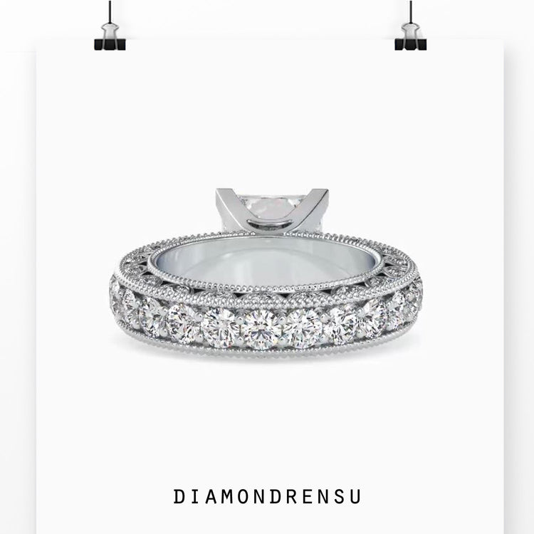 UK diamond ring featuring custom side stones and pave band.