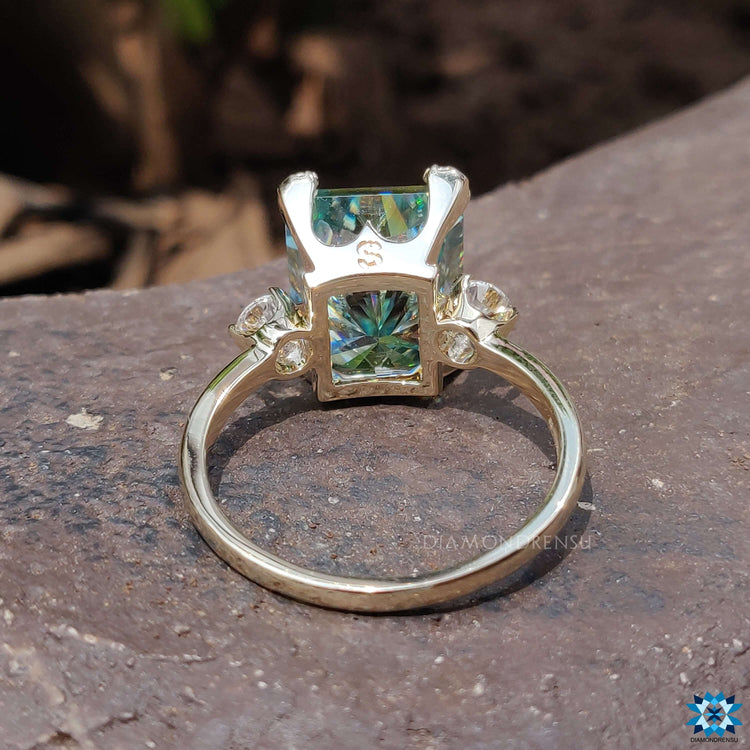 Yellow gold ring with radiant cut center stone.