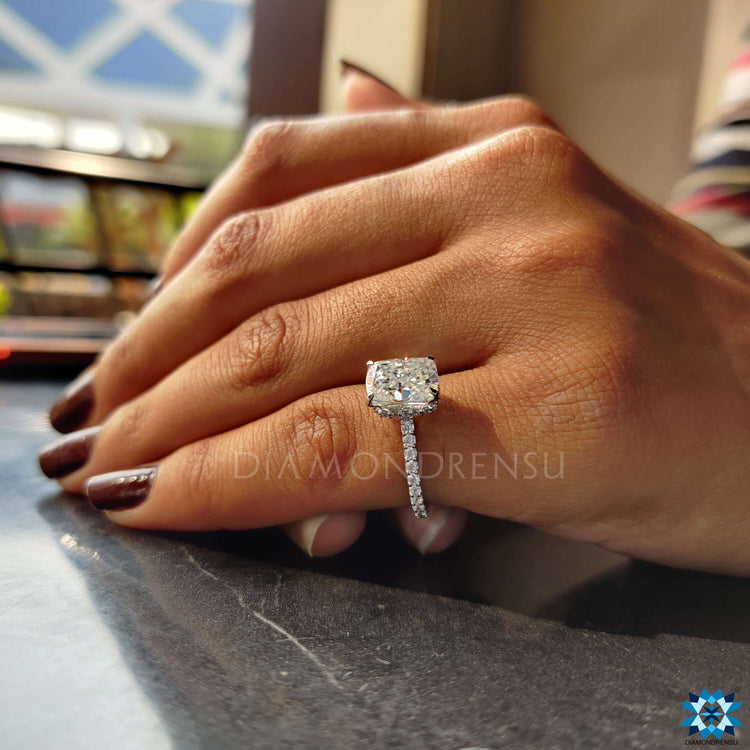 Cushion cut moissanite ring featuring a hidden halo.