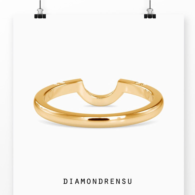 Yellow gold wedding band crafted with curved design.