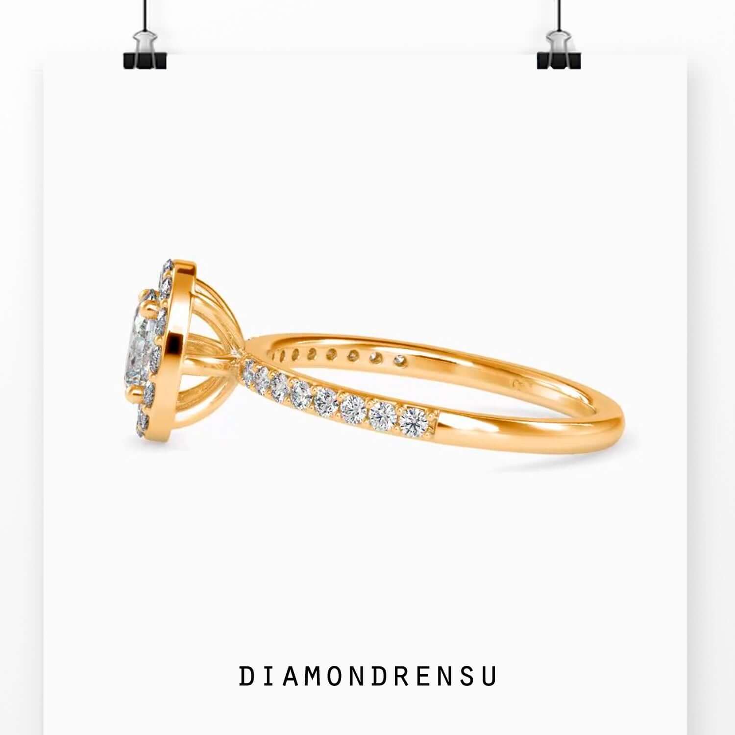 Custom engagement ring with oval diamond and pave shoulders.