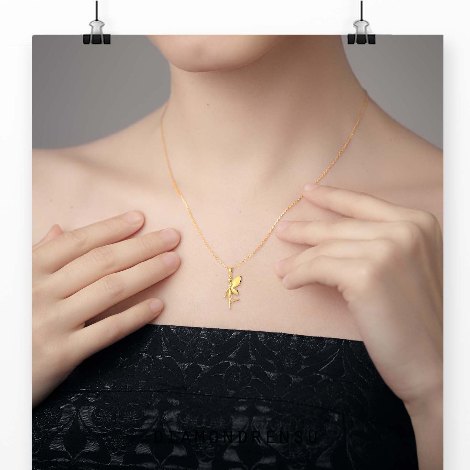 Flying angel pendant with detailed gold finish.