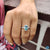 Moissanite halo ring featuring a cyan blue pear cut stone in prong setting.
 Moissanite halo ring featuring a cyan blue pear cut stone in prong setting.