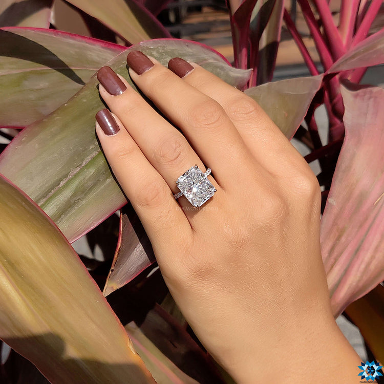 White gold engagement ring with radiant and round cut stones.