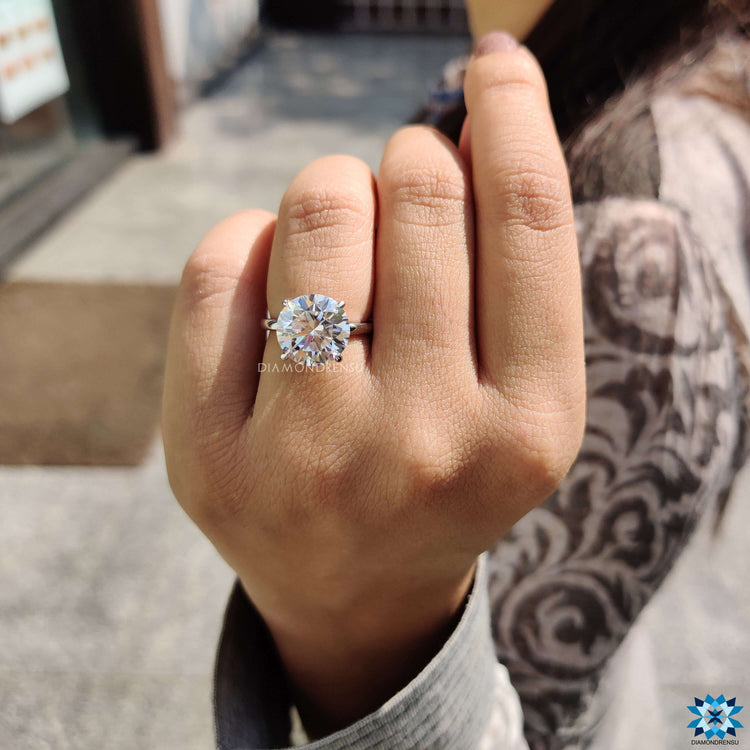 Moissanite solitaire ring featuring round cut center stone.