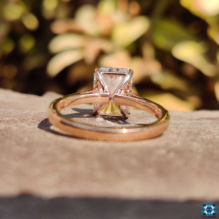 Radiant cut solitaire ring in cathedral setting.