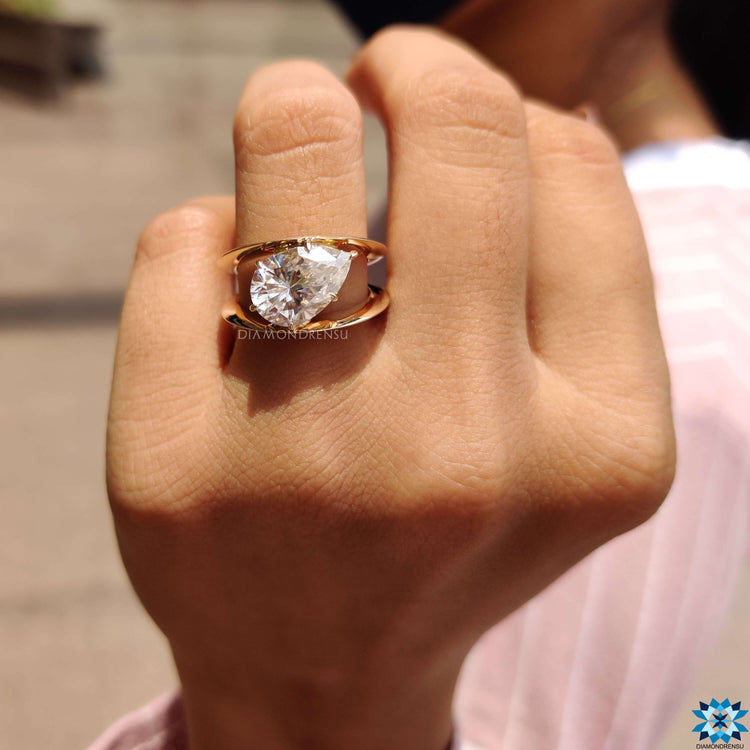 Buy moissanite ring with pear shaped center stone.