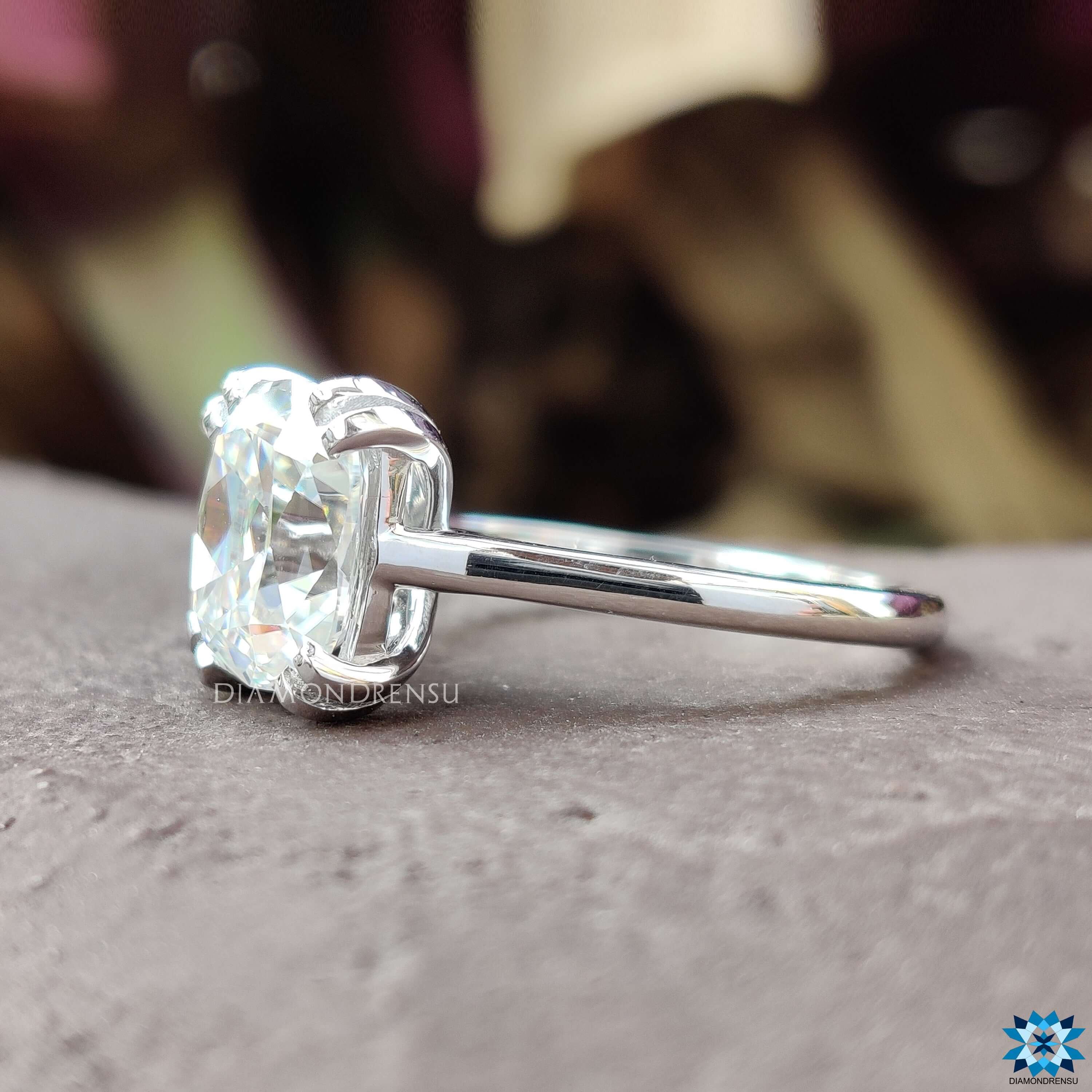 Double prong solitaire setting with OEC cushion cut stone.