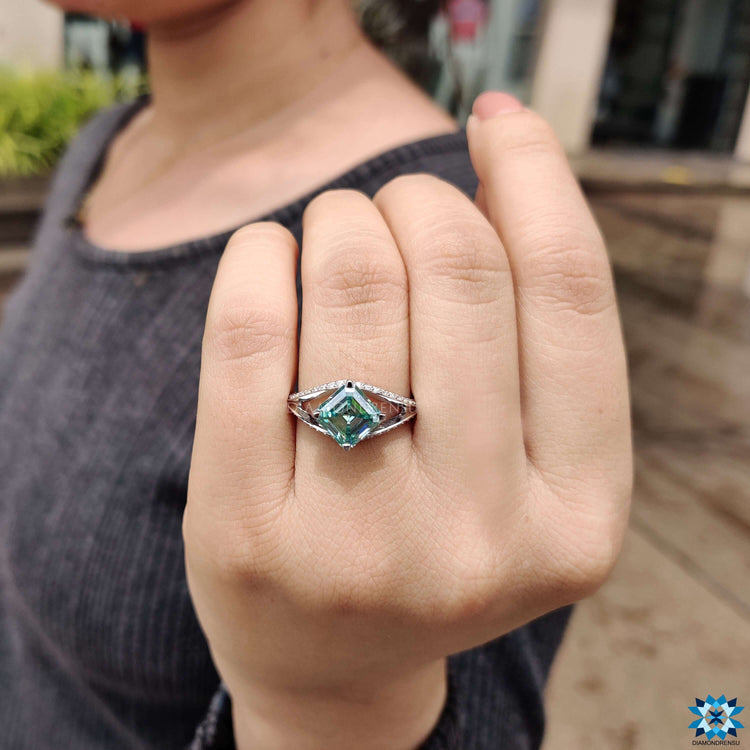 Cyan blue moissanite ring in white gold setting.