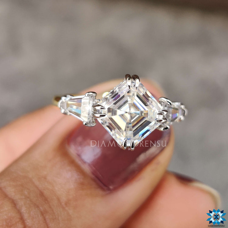 Handmade ring with prong setting and tapered baguette accents.