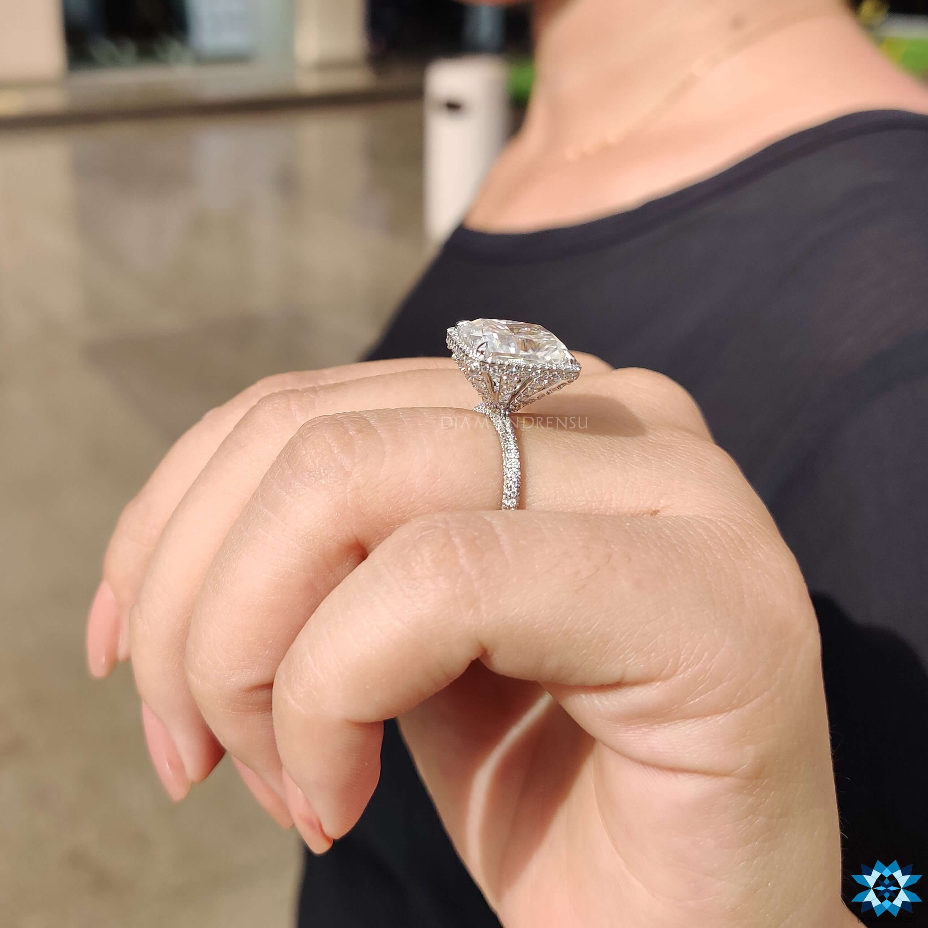 Prong setting on white gold cushion moissanite ring.