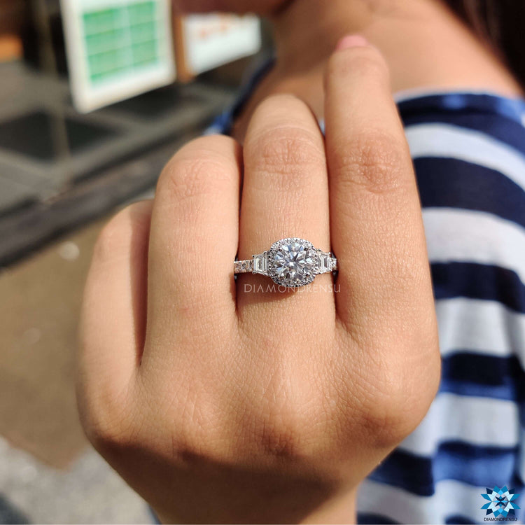 White gold ring featuring round cut center moissanite and halo design.