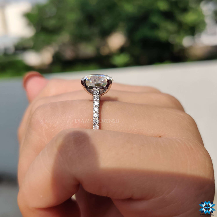 Custom octagon cut moissanite ring with 4 tab prong setting.