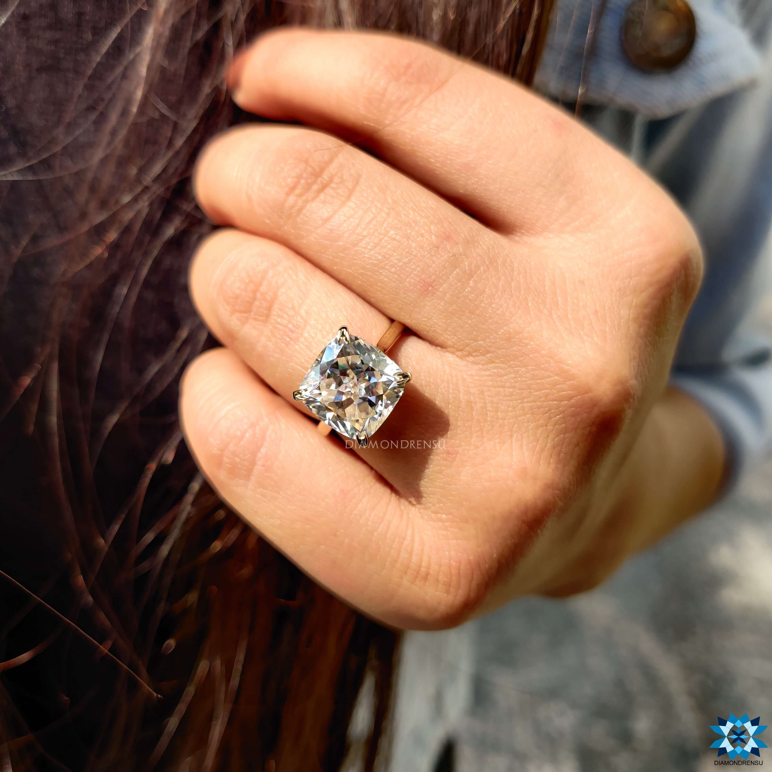 Prong set cushion Rensu cut moissanite engagement ring in gold.