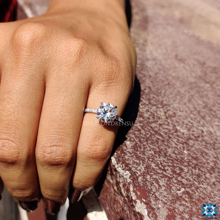 White gold ring with round cut moissanite center stone.