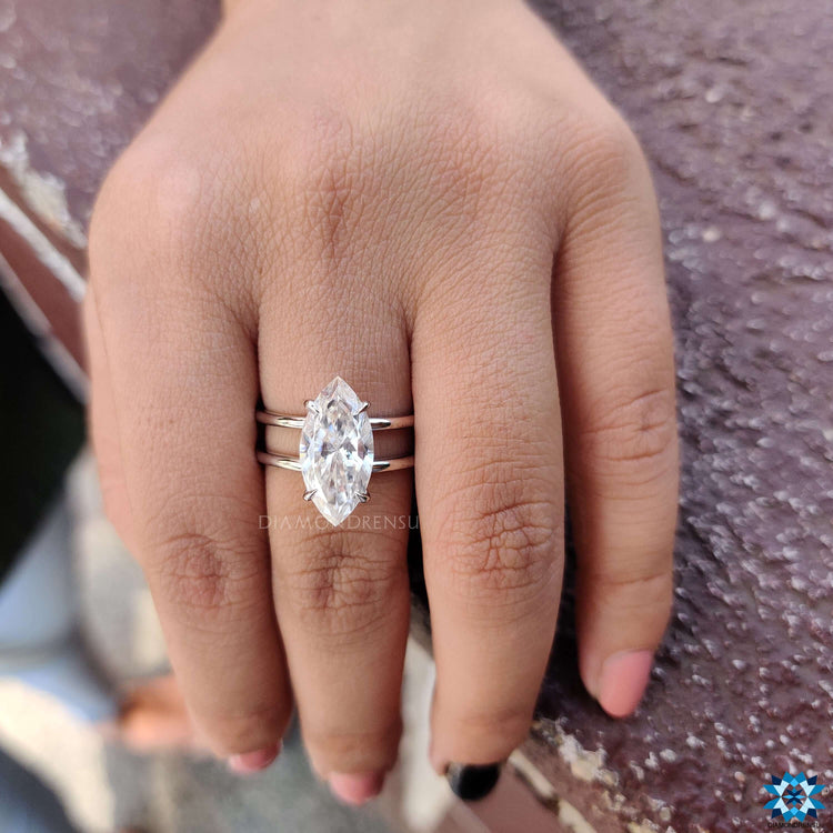 Unique white gold ring with marquise moissanite and dual shank.